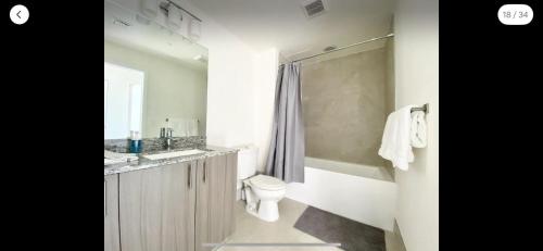 a bathroom with a toilet and a sink and a shower at 2 bed 2 bath Luxury Condo in Miami