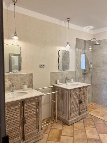a bathroom with two sinks and a shower at Les Demeures de Piana in Piana