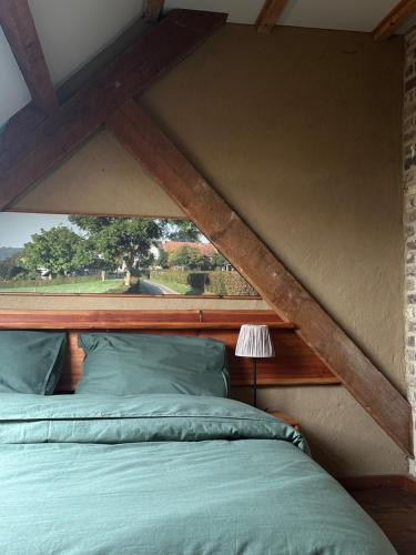 a bed with a wooden frame in a room at Landhuis Bovenste Bos in Epen