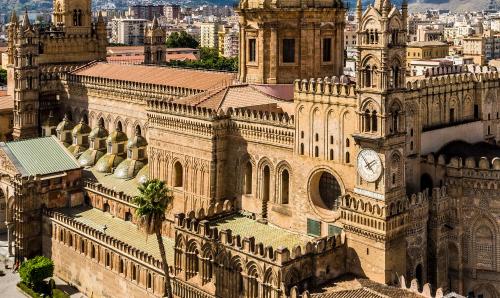 an old building with a clock tower in a city at Ducrot Apartment in Palermo