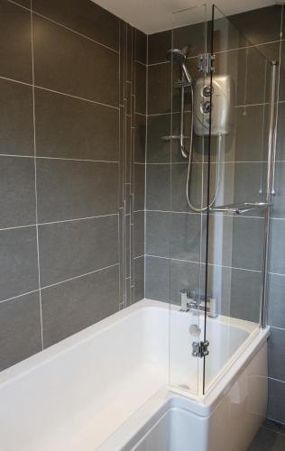 a bathroom with a shower with a bath tub at Hope Apartments Belfast - South in Belfast