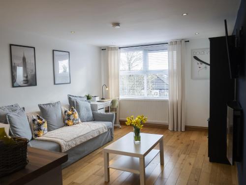 a living room with a couch and a table at Hope Apartments Belfast - South in Belfast