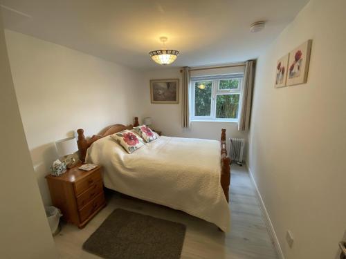 a bedroom with a bed and a window at Self catering private annex near Ferndown in Ferndown