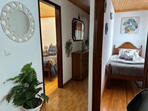 a hallway with a bed and a mirror in a room at Dreams in Xisto in Piódão