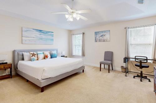 a bedroom with a bed and a ceiling fan at East Bay Getaway in Navarre