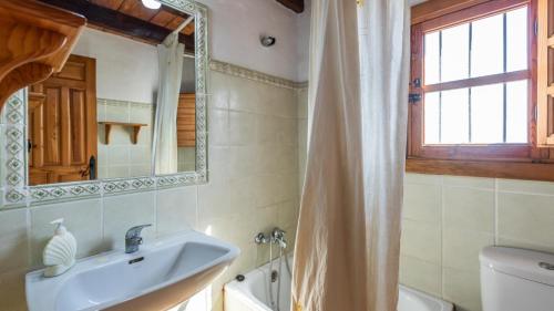 a bathroom with a sink and a mirror at Casa Rocio Almachar by Ruralidays in Almáchar