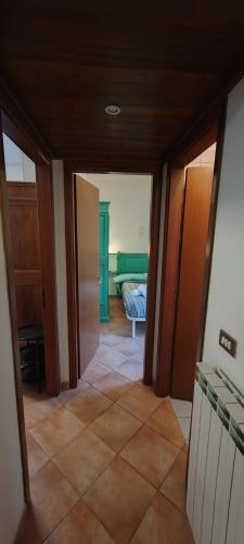 a hallway of a house with a room with a couch at Casa Corone in Alfedena