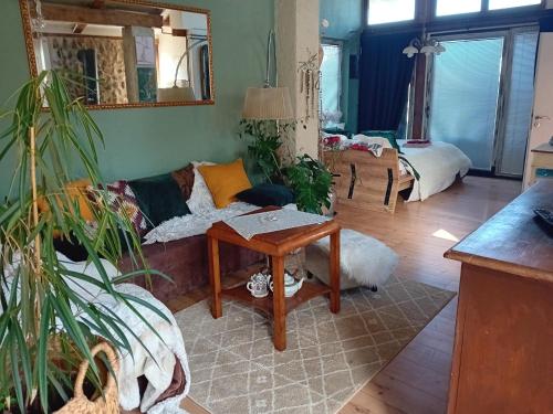 een woonkamer met een bank en een tafel bij ROSE Room of 40m2 with terrace 25m2 in Ljubljana