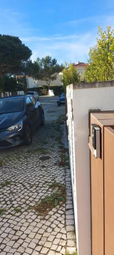 a car parked in a parking lot next to a wall at FontesMil in Vila Nova de Milfontes