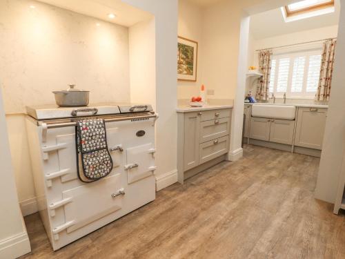 a kitchen with a stove and a sink at Riverdale House in Skipton