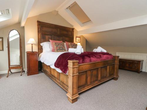 a bedroom with a large wooden bed in a room at Riverdale House in Skipton