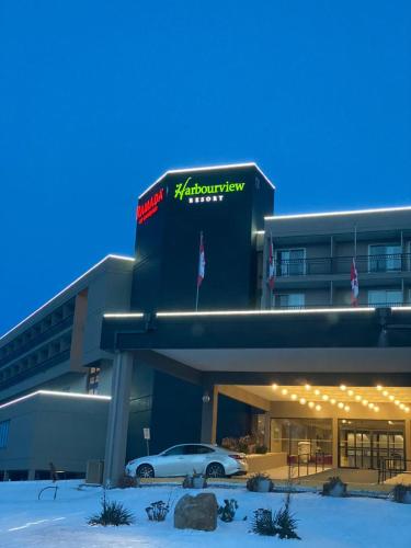 a building with a car parked in front of it at Ramada by Wyndham Belleville Harbourview Conference Center in Belleville