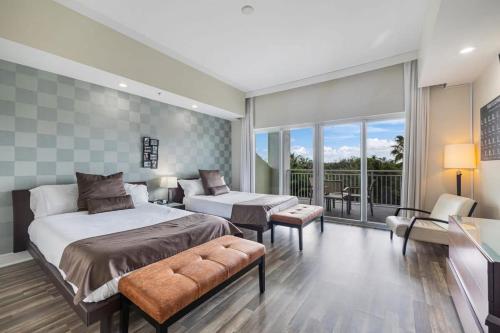 a bedroom with a large bed and a balcony at Stylish 2 Story residence on the golf - by Viac in Miami