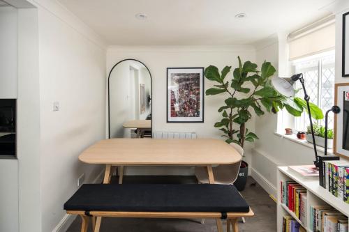 a dining room with a table and a plant at Ideal 1BD Flat Shoreditch For City Explorers in London