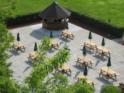 a group of picnic tables with umbrellas and a fountain at Ramada by Wyndham Belleville Harbourview Conference Center in Belleville