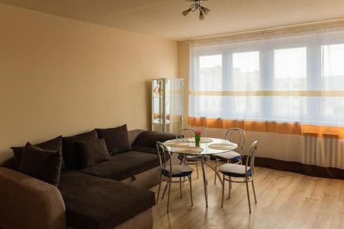 a living room with a couch and a table and chairs at BB Panorama apartman in Budapest
