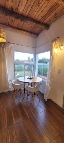 a dining room with a table and two chairs at Casa Amor in Capilla del Monte