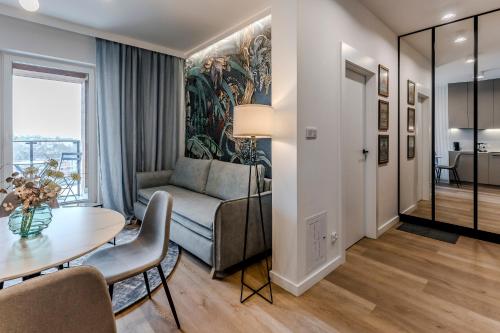 a living room with a couch and a table at Apartament Agat Lublin Centrum in Lublin