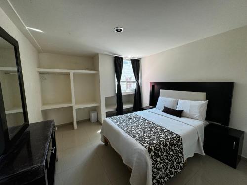 a bedroom with a large bed and a window at PEDRERA 39 in San Felipe Hueyotlipan