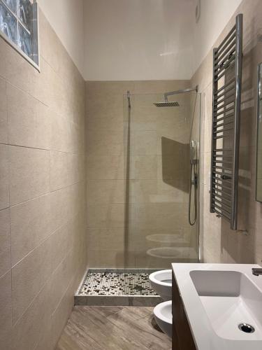 a bathroom with a shower and a sink and a toilet at Elena Rooms in Taranto