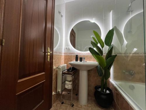 a bathroom with a sink and a mirror at Dúplex Pico Sacro in Lestedo