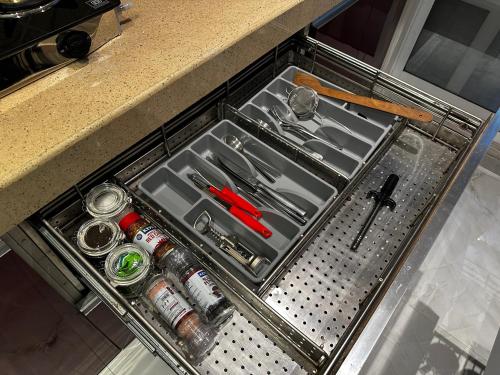 a drawer in a counter with tools in it at Luxury 2 BHK Tropical Apartment in Khar West in Mumbai