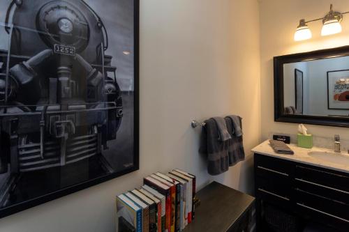a bathroom with a picture of a train on the wall at Charming Savannah Penthouse: Grand Views & Dual Parking in Savannah