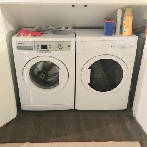 a washing machine and a washer in a room at Historic Farmhouse by Nature Preserve in Charleston