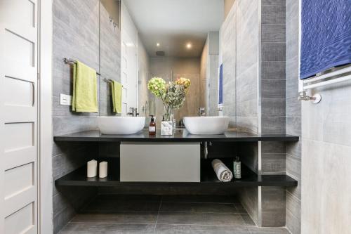 a bathroom with two sinks on a counter at Premium Belgravia Harrods Apartment in London