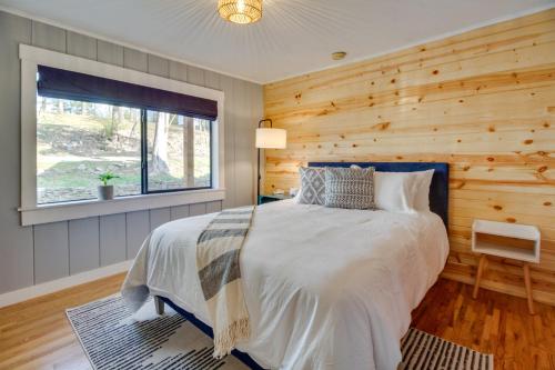 - une chambre avec un lit et un mur en bois dans l'établissement Henderson Cabin with Deck and Scenic Lake Views!, à Henderson