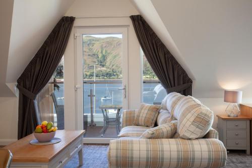 a living room with a couch and a table at Lochiel Villa Guest House in Fort William