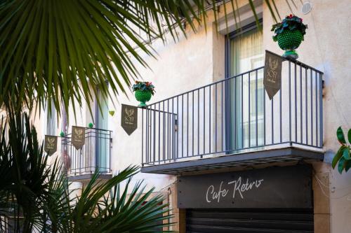 a building with a balcony with plants on it at Sofi' Center Rooms in Sciacca