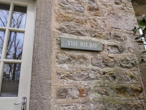 a sign on the side of a stone building at Bilbo in Lancaster