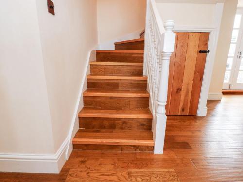 a staircase with wood floors and white railings at Bilbo in Lancaster