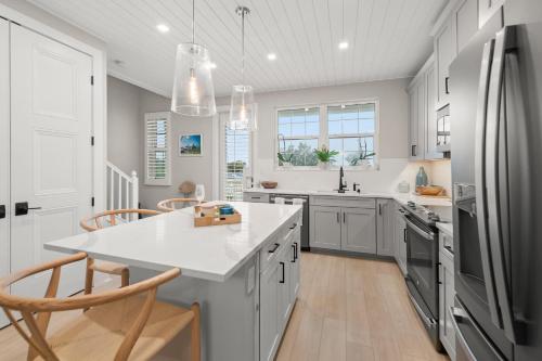 a kitchen with a sink and a refrigerator at Shore To Escape at Hunter's Point in Cortez