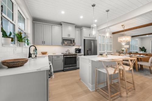 an open kitchen and dining room with white cabinets at Shore To Escape at Hunter's Point in Cortez