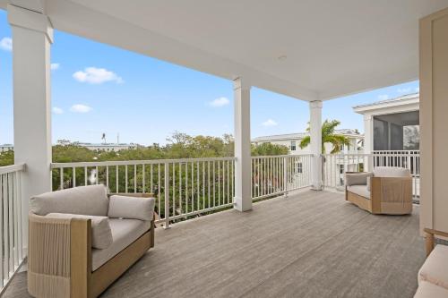 a porch with a couch and chairs on a balcony at Shore To Escape at Hunter's Point in Cortez