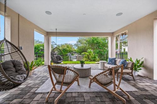 a patio with two chairs and a swing at Shore To Escape at Hunter's Point in Cortez