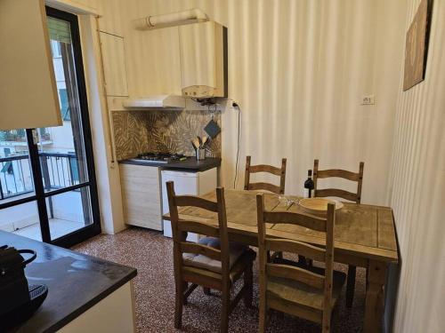 a kitchen with a table and chairs and a kitchen with a refrigerator at Genova in Genoa