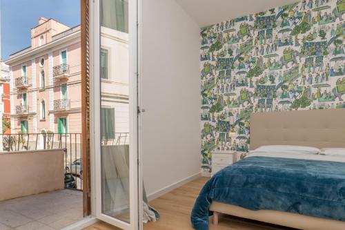 a bedroom with a bed and a large window at Relais San Demetrio - Modern & Central rooms in Salerno