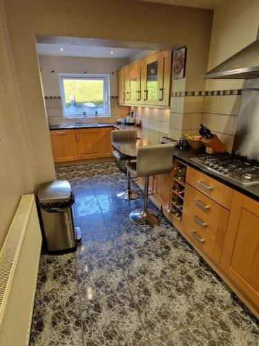 a kitchen with a counter and a table in it at Cribden Hill View in Rawtenstall