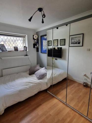 a room with two beds and a glass wall at Cribden Hill View in Rawtenstall