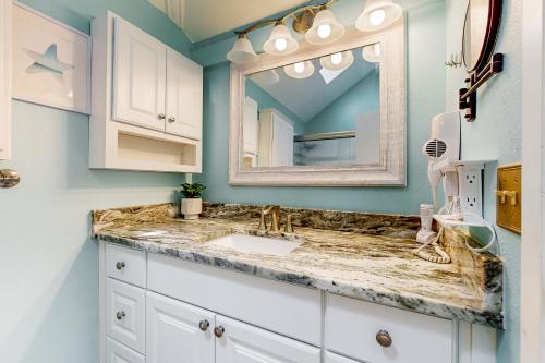 a bathroom with a sink and a mirror at Peaceful River Bungalow in Crystal River