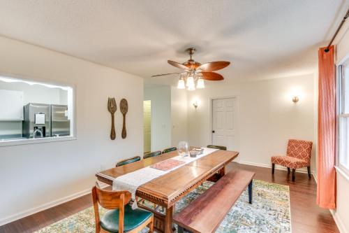 a dining room with a table and chairs and a ceiling fan at Charming Seneca Home - 3 Mi to Memorial Stadium! in Seneca