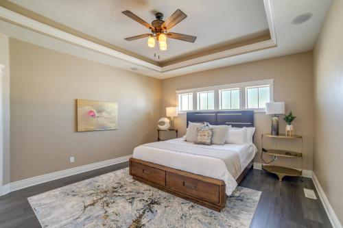 a bedroom with a bed and a ceiling fan at Welcoming Rigby Home with Game Room and Fire Pit! in Rigby
