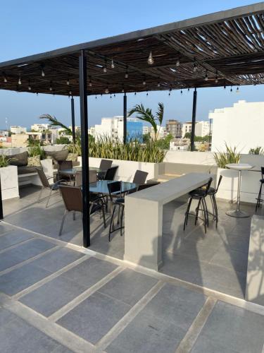 a patio with a table and chairs on a roof at Coco Live Suites in Playa del Carmen