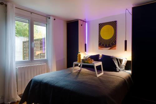 a bedroom with a bed with a table on it at Garden Chic, JO PARIS 2024, Paris, Stade de France, Parc des expo, Asterix in Aulnay-sous-Bois