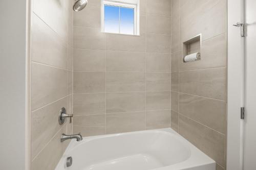 a bathroom with a shower with a white tub at Baydream Believer at Hunter's Point in Cortez