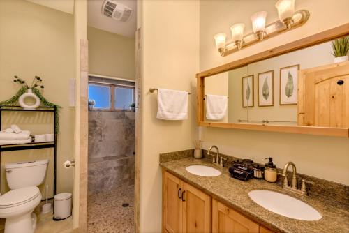 a bathroom with two sinks and a toilet at Peaceful Desert Retreat - Stunning Views - Pool Spa, Backyard, Music - Tucson ! in Tucson