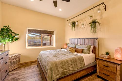 a bedroom with a bed and a window at Peaceful Desert Retreat - Stunning Views - Pool Spa, Backyard, Music - Tucson ! in Tucson